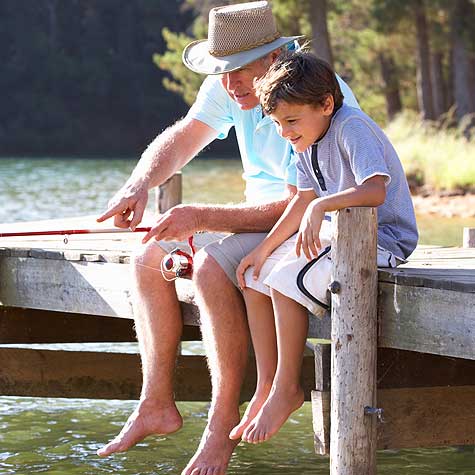 image of a man and boy fishing on a dock