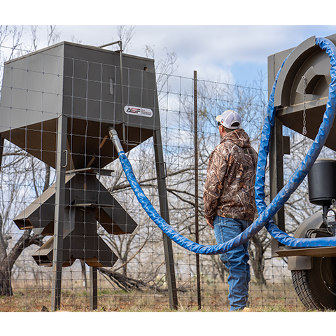 Man filling deer feeder