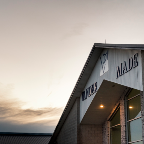Entrance to the VanderMade Dairy Farm barn with the sunrise in the background. 