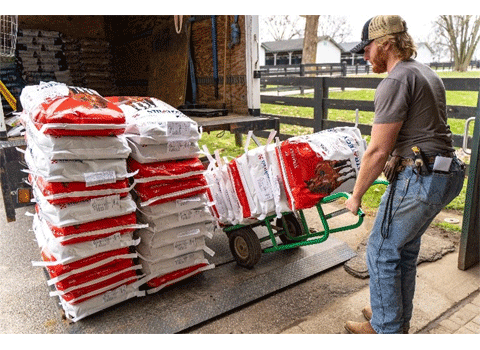 Man unloading Purina horse feed